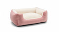 A pink and white dog bed with a soft, cushioned interior and exterior.