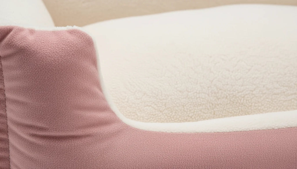 Close-up of a dusty rose pillow with a white faux fur insert on a beige background
